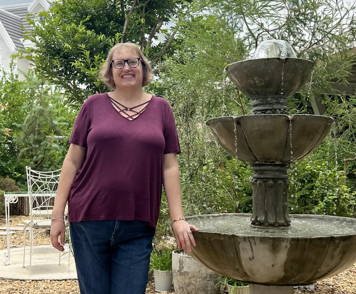 Allison visiting a garden fountain